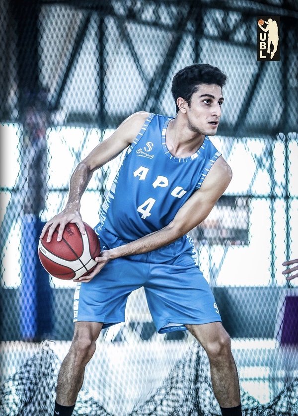 Hamza holding a basketball during a basketball game